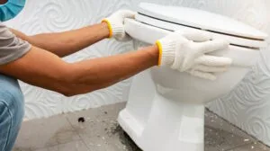 trusted handyman performing toilet replacement and installation
