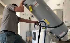 Technician performing water heater installation and replacement