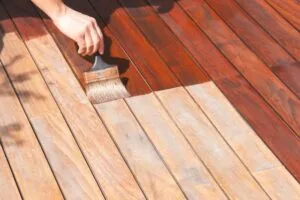 Professional handyman performing deck painting and remodeling