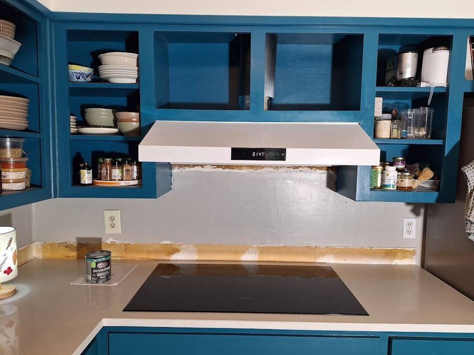 Finished range hood installation with increased cooktop clearance