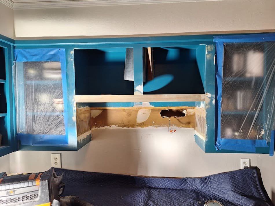 Rebuilt and painted cabinet bottom above kitchen rage